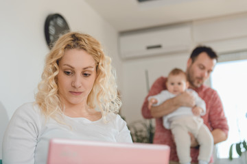 Woman using laptop at home office