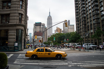 Cab and Empire State Building under a Grey Sky in Manhattan, New York, USA