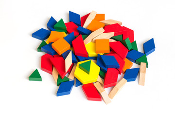 Multicolored pattern blocks on a white wooden background.Isolate. 