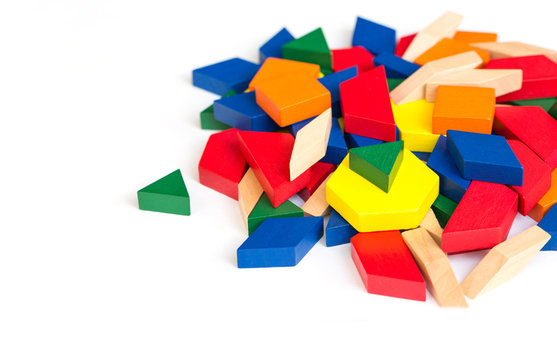 Multicolored pattern blocks on a white wooden background.Isolate. 