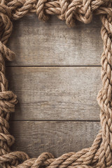 Rope frame on wooden background