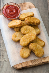 Fried chicken nuggets on wooden table

