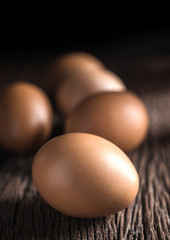 close up brown eggs on wood table still life photography.