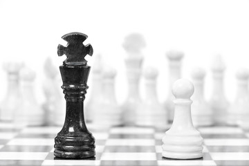 Black king and white  pawn on chessboard