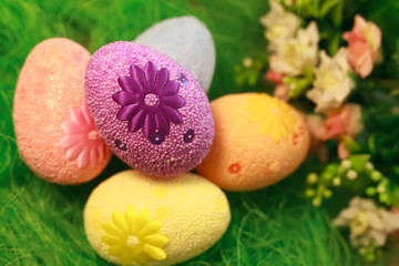 Decorative eggs on green grass. Chicken basket. Concepts Easter, eggs, hand made