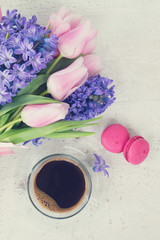 Obraz na płótnie Canvas Pink tulips and blue hyacinths fresh flowers with cup of coffee, holiday breakfast, retro toned