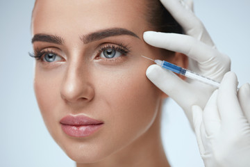 Woman Face Receiving Beauty Injections In Skin