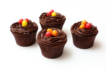Easter cupcakes decorated with nest chocolate cream and sugar eggs on a white  background