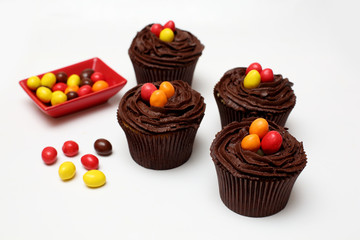 Easter cupcakes decorated with nest chocolate cream and sugar eggs on a white  background