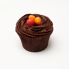 Easter cupcakes decorated with nest chocolate cream and sugar eggs on a white  background