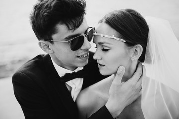 Elegant young bride and groom on the beach