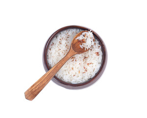 Wooden spoon in ceramic bowl with rice isolated on white background