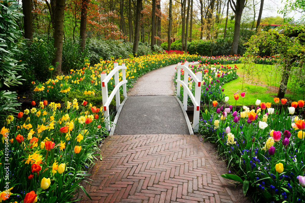 Sticker stone walk way winding in spring formal flower garden keukenhof, holland, retro toned