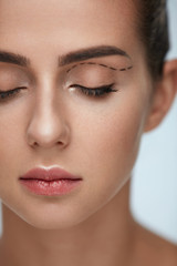 Plastic Surgery Operation. Woman Face With Black Surgical Lines