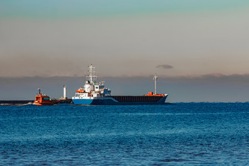 Fototapeta premium Blue cargo ship leaving Riga and entering Baltic sea