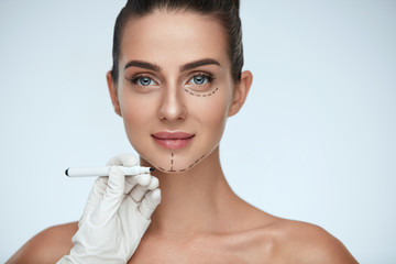 Treatment. Beautician Drawing Surgical Lines On Woman Face