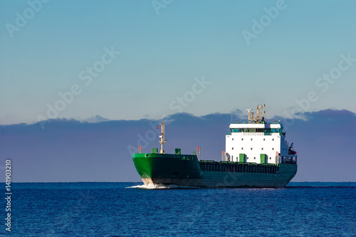 Green Cargo Ship Moving In Still Water Of Baltic Sea Stock Photo