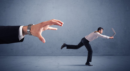 Businessman running from hand