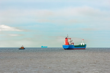Fototapeta premium Blue cargo ship entering the Baltic sea. Riga, Europe