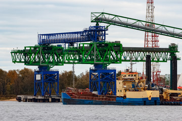 Fototapeta premium Blue cargo ship loading in the port of Riga, Europe