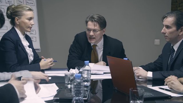 Mad boss yelling at employees with a megaphone