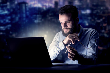 Businessman in the office at night