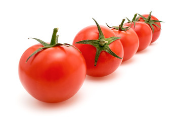 Ripe red tomatoes closeup on white