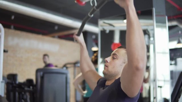 Young athletic man is exercising in the gym