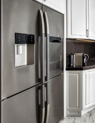 Interior of modern kitchen with big fridge refrigerator