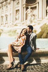 tourist couple on travel by Trevi Fountain in Rome, Italy.