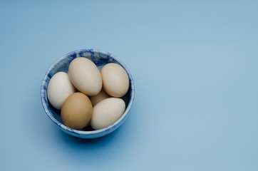 unpainted easter eggs on a saucer
