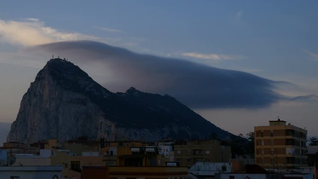 Morning time-lapse of impressive cloud formation above the Gibraltar Rock and La Linea de la Concepcion cityscape in Spain.