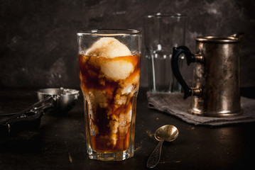 Cold coffee, frappe, frapuchchino. Affogato coffee with ice cream, On a concrete gray table. Toned, vintage. Coffee pot, spoon for ice cream, second glass. Horizontal, copy space