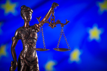 Law concept Gavel and Lady of Justice on wooden table,  EU flag