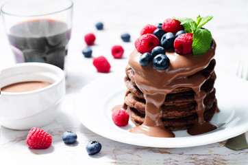 chocolate pancake with blueberries, raspberies and chocolate sauce