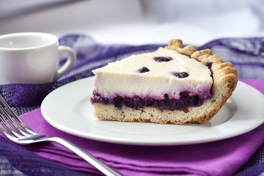 Piece of cheesecake with blueberries on a plate