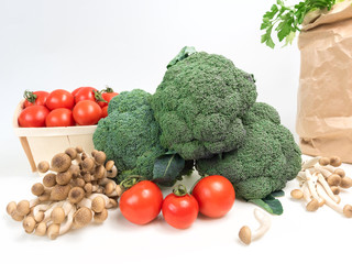 Still life vegetables cabbage broccoli with tomatoes mushrooms green leaves isolated white background