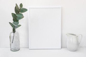 White frame mockup, eucalyptus branch in glass bottle, pitcher, styled minimalist clean image for product marketing, social media