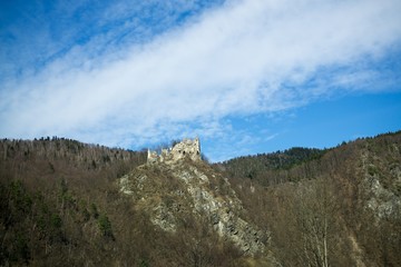 Fototapeta na wymiar Castle on the rock in colorful woods during autumn. Slovakia