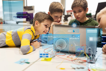 kids, laptop and invention kit at robotics school