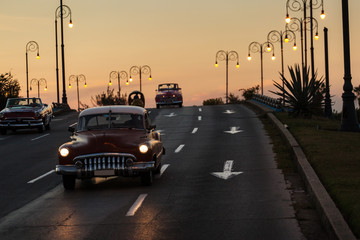 Old cars on street of Havana at sunset, Cuba