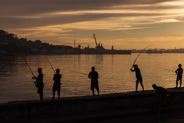 Fisher men fishing on sunrise in Havana, Cuba