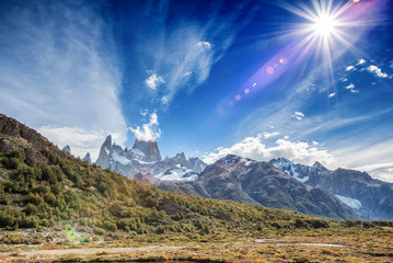 Mount Fitz Roy in Patagonia in Argentina and its neighboring granite towers with lens flare from...