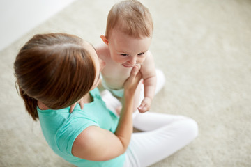 happy young mother with little baby at home