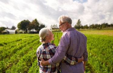 happy senior couple at summer farm