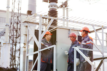 workers repairing a transformer at the power station.
