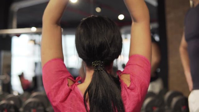 A young woman is engaged in a gym. 4K