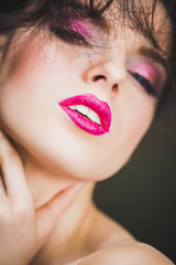 Fototapeta premium Face of a beautiful woman with makeup, hairdo and passionate glance
