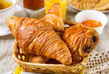 Croissants pastry for breakfast with tea and orange juice - 141915666