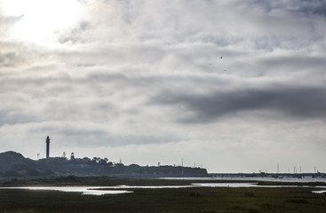 Fototapeta na wymiar El Rompido lighthouse and marina at sunrise from marshlands